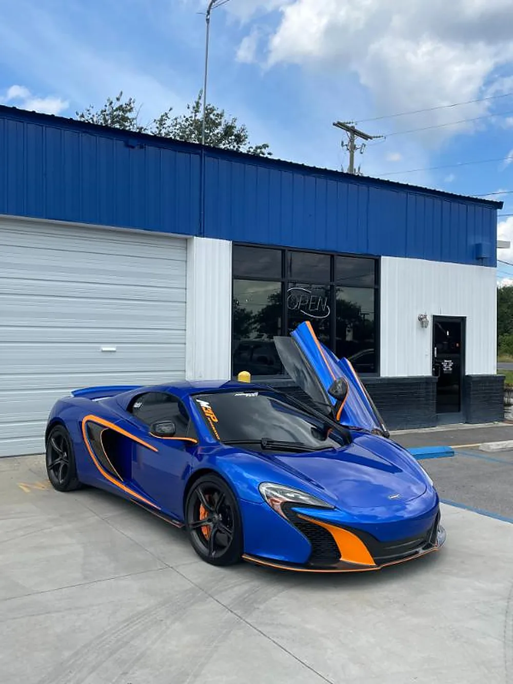 Blue McLaren being tinted in the bay