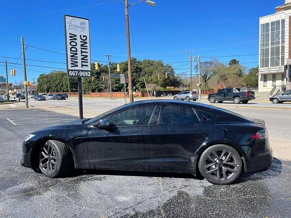 Black sedan parked outside after tinting