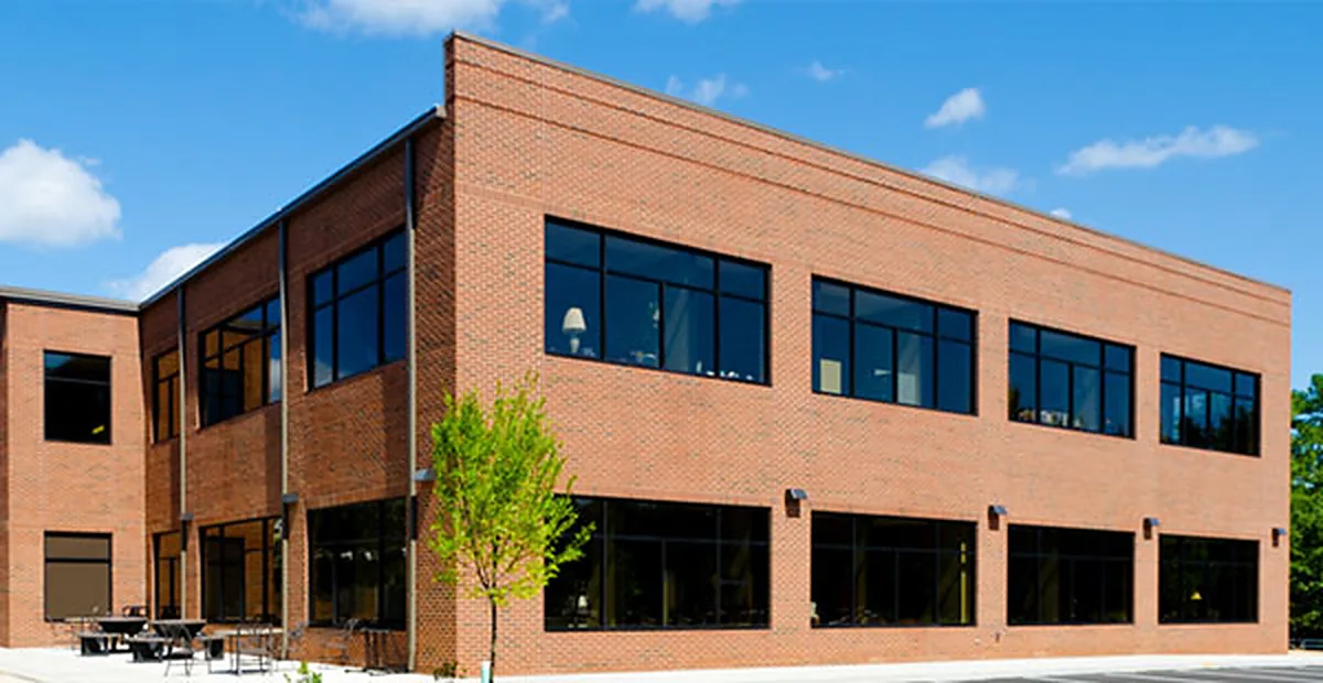 Two-story brick office building with tinted windows