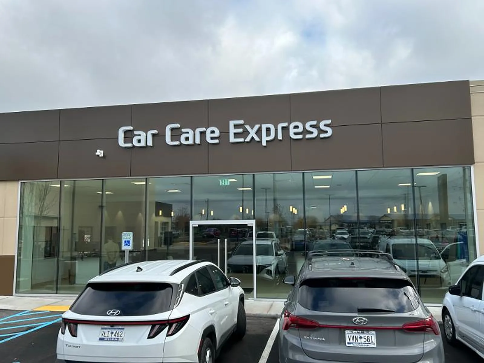 Dealership showroom glass before window film, bright glare