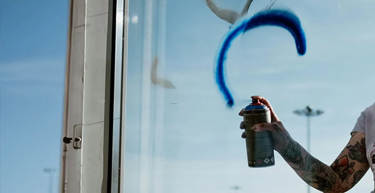 Installer applying protective film to storefront glass